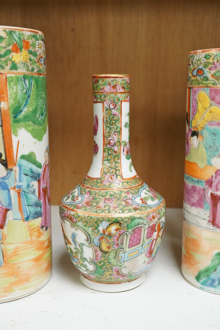 Two 19th century Chinese famille rose cylindrical vases and a similar bottle vase, 21cm